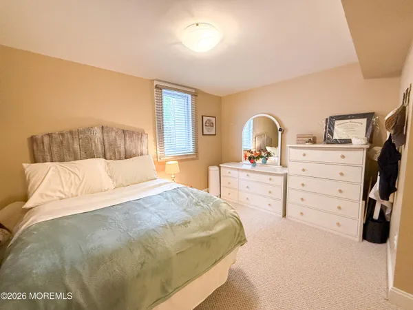 a bathroom with a double vanity sink a toilet and a mirror