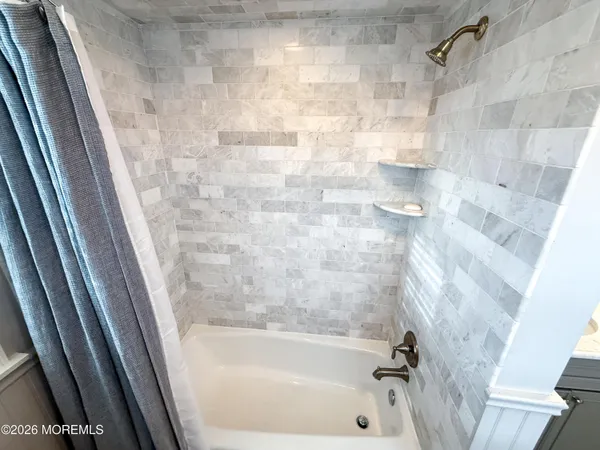 a bedroom with a bed lamps and wooden floor