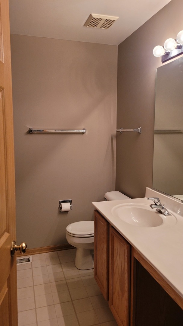 2584 Golf Ridge Circle Naperville, IL 60563 - Photo 10 of 14 a bathroom with a sink a toilet and a mirror