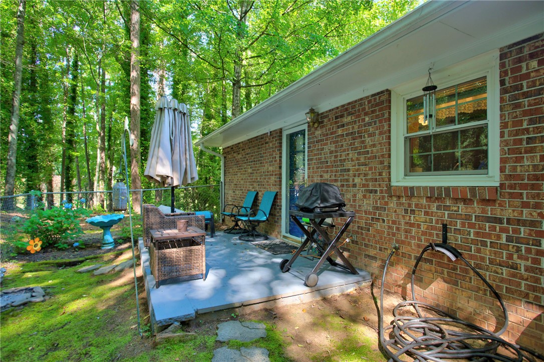 104 Laurel Lane Seneca, SC 29678 - Photo 34 of 36 A tranquil patio space offers private outdoor relaxation amidst a lush, wooded backdrop.