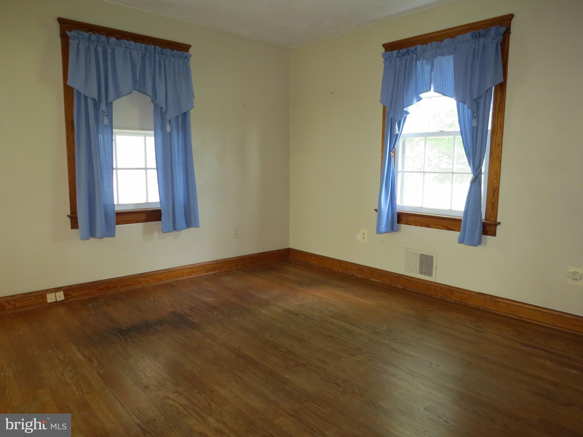 4418 Upper Beckleysville Road Hampstead, MD 21074 - Photo 14 of 25 an empty room with wooden floor and windows