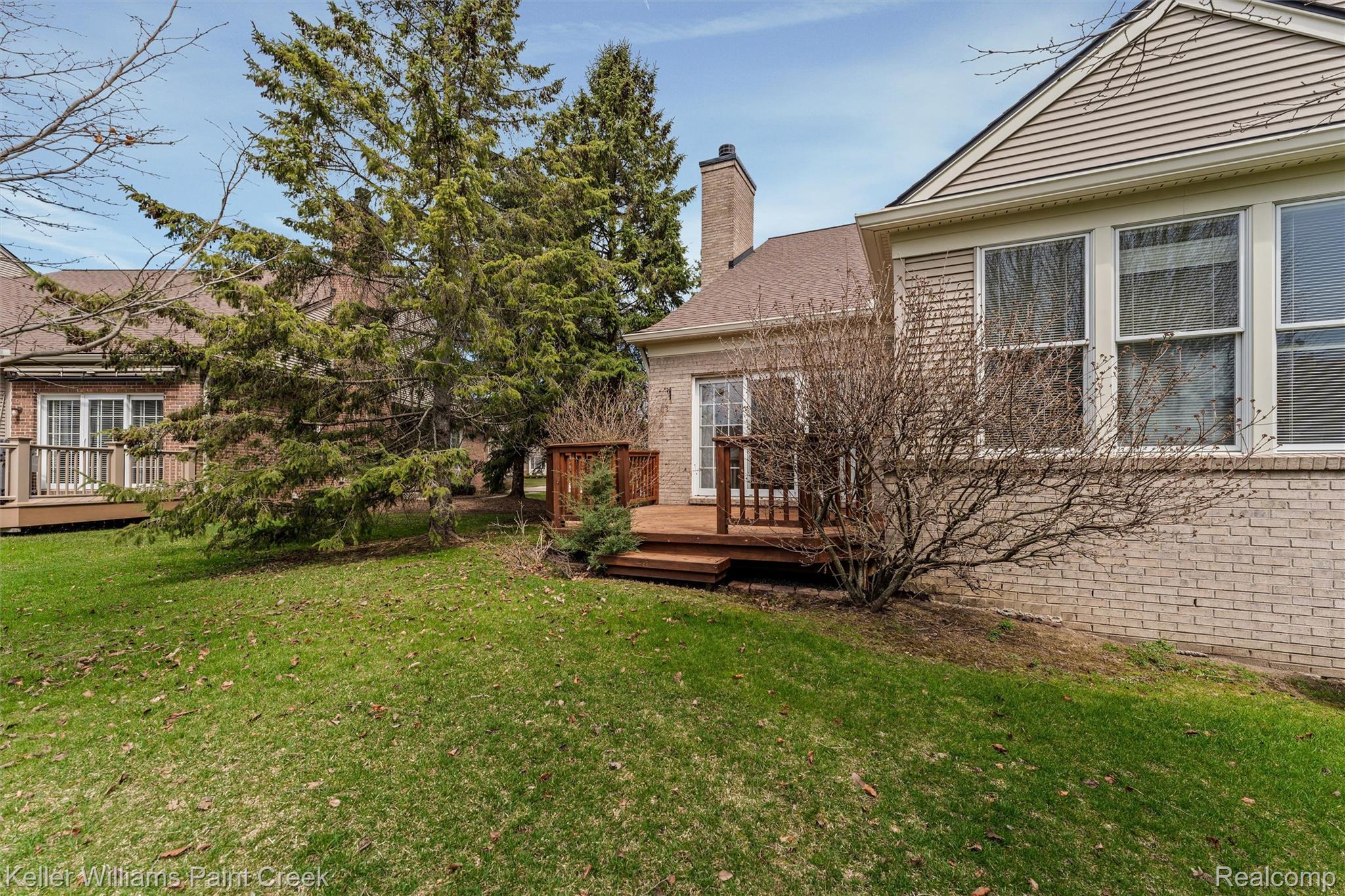 1685 Maple Creek Court Rochester, MI 48306 - Photo 39 of 49 View of grassy yard featuring a deck