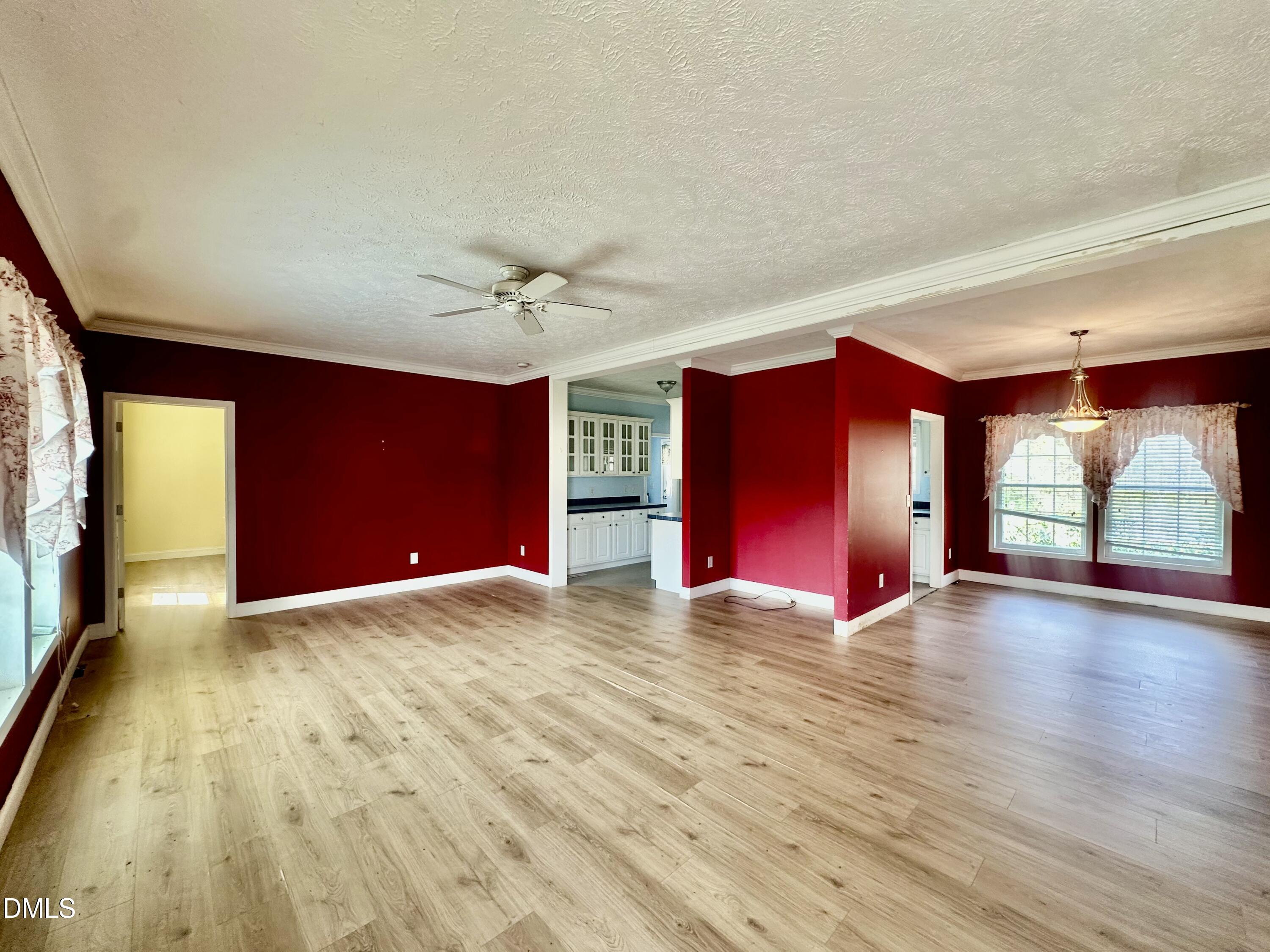 155 Collin Drive Roxboro, NC 27574 - Photo 4 of 20 a view of an empty room with window and wooden floor