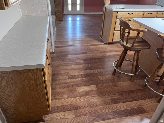 1766 Pine Rd Pine Canyon Tooele, UT 84074 - Photo 8 of 16 Wood-finish flooring throughout, complemented by light-toned countertops, and wood cabinetry with dark pulls