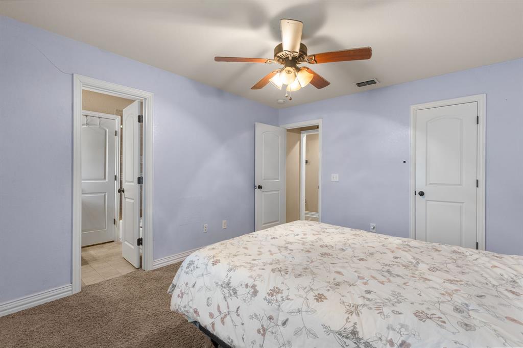 4504 Jennings Avenue Wichita Falls, TX 76310 - Photo 18 of 26 a bedroom with a bed and a chandelier