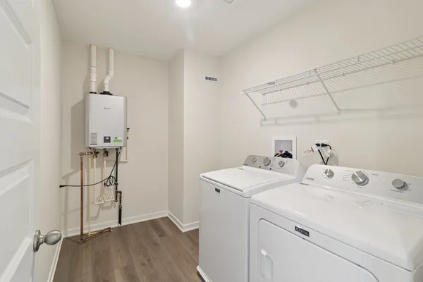 a utility room with closet dryer and washer