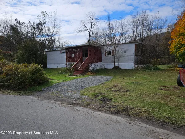 a view of a barn in the middle of a yard