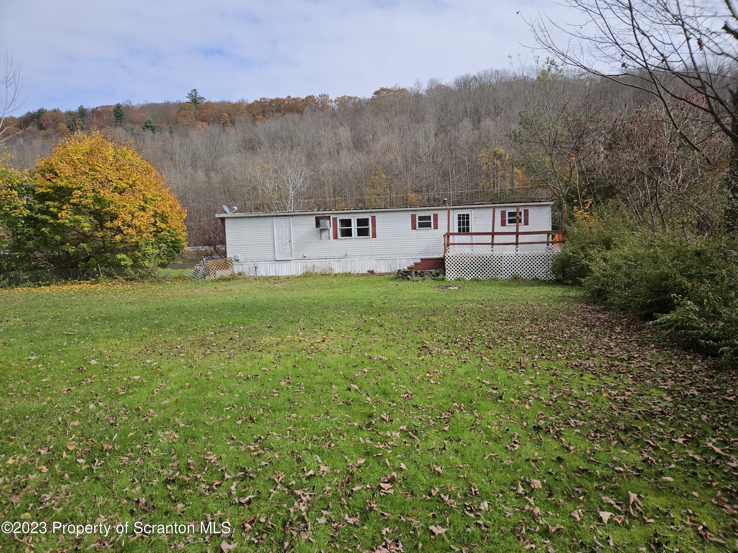 65 South Center Street Hop Bottom, PA 18824 - Photo 12 of 28 a view of a big yard with an houses