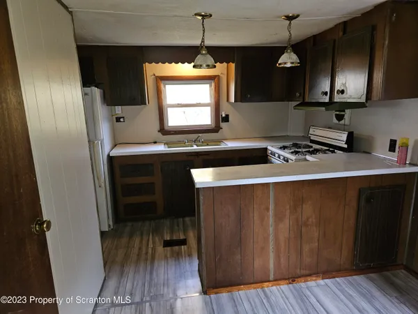 a kitchen with wooden floor and a sink