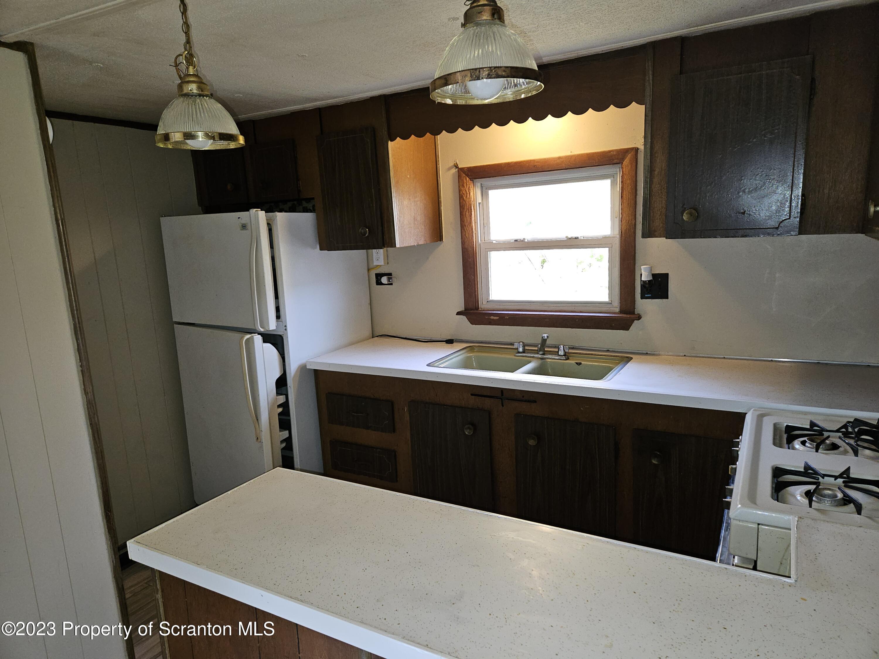 65 South Center Street Hop Bottom, PA 18824 - Photo 17 of 28 a kitchen with stainless steel appliances a refrigerator and a sink