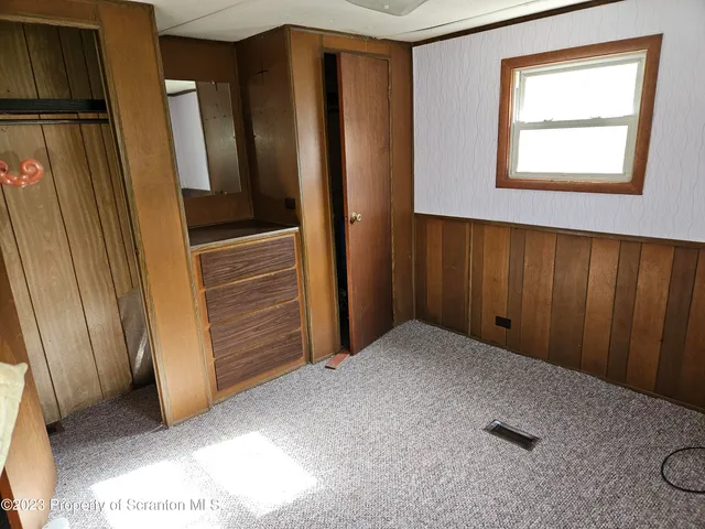 an empty room with windows and closet