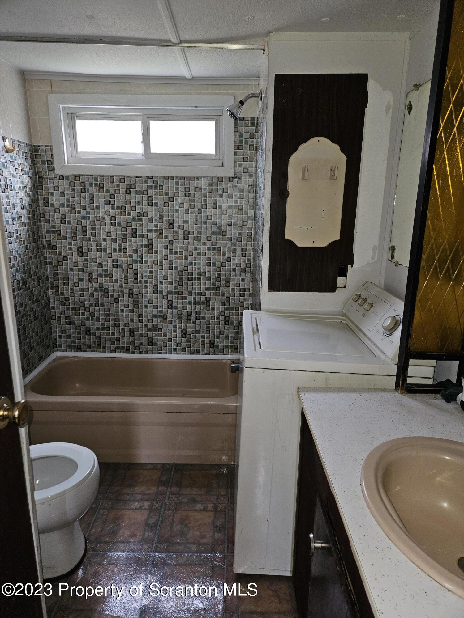 65 South Center Street Hop Bottom, PA 18824 - Photo 27 of 28 a bathroom with a sink a toilet and a bathtub