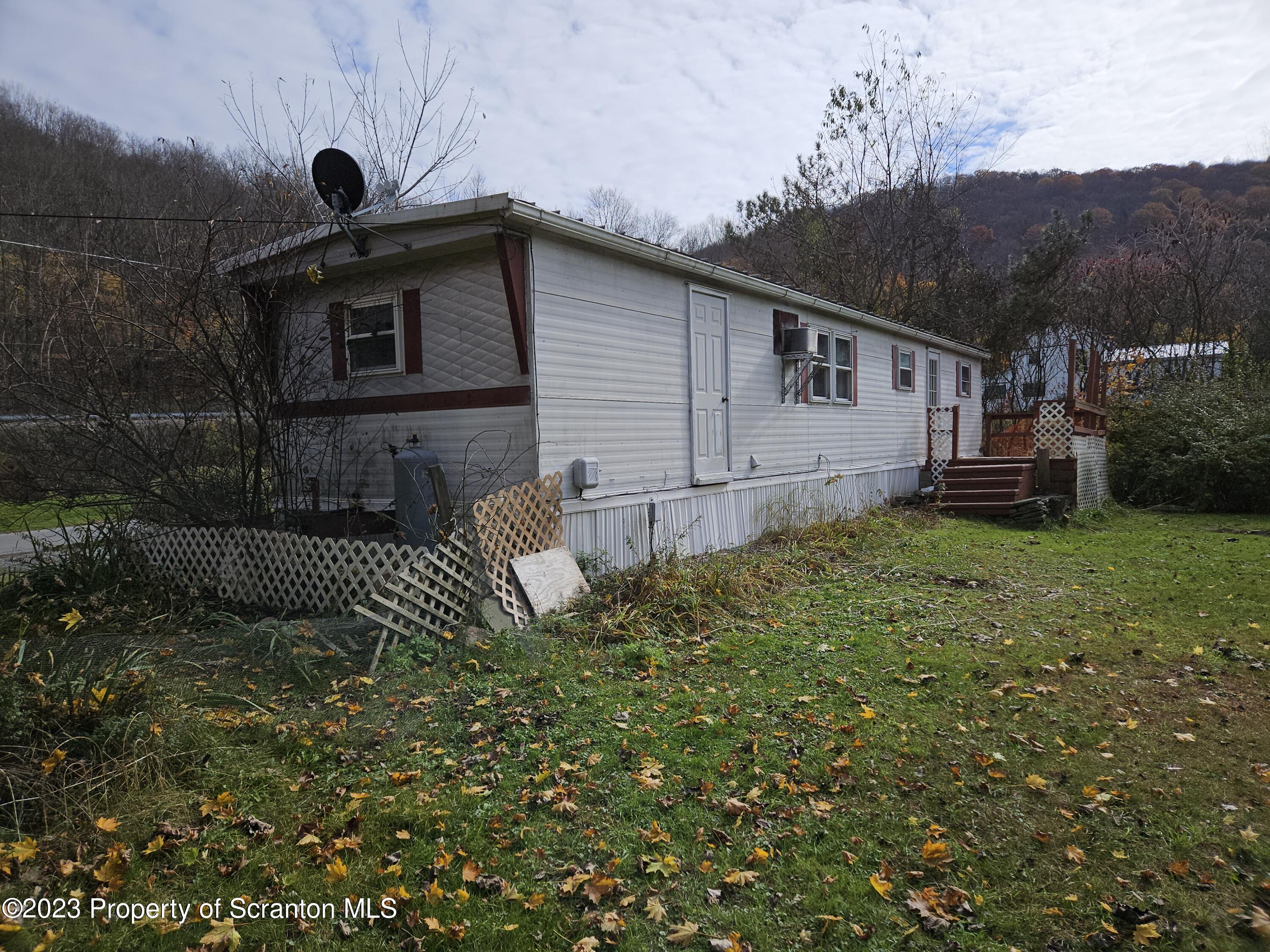 65 South Center Street Hop Bottom, PA 18824 - Photo 7 of 28 a front view of a house with garden