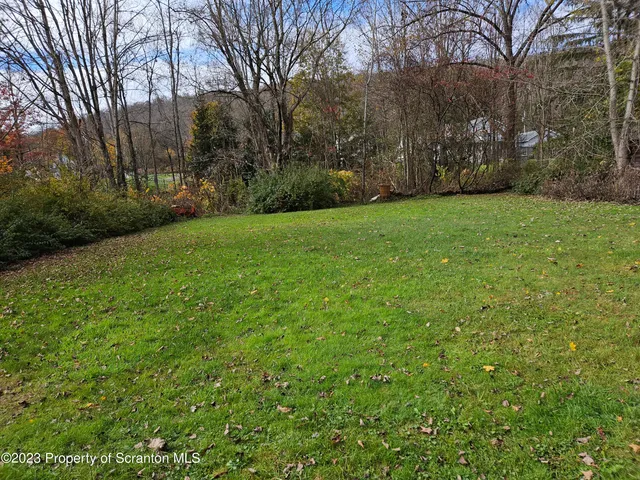 a backyard of a house with lots of green space