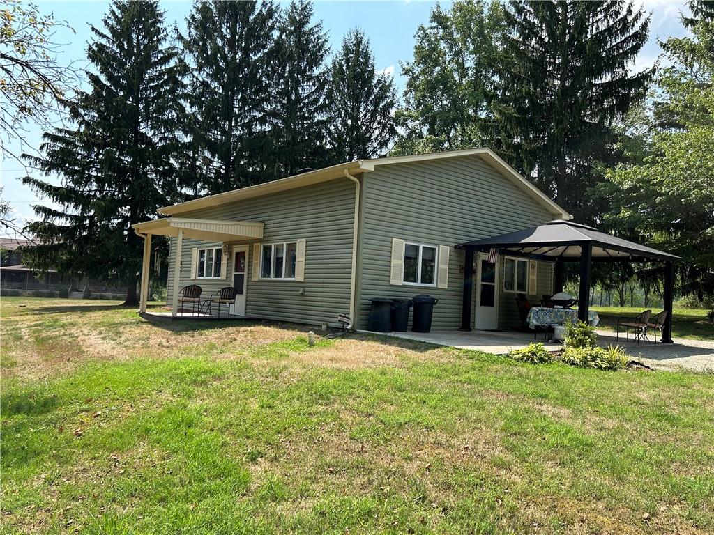 240 Martin Road Scottdale, PA 15683 - Photo 1 of 16 a backyard of a house with barbeque oven table and chairs