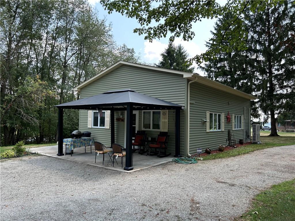 240 Martin Road Scottdale, PA 15683 - Photo 2 of 16 a view of a house with a yard and sitting area