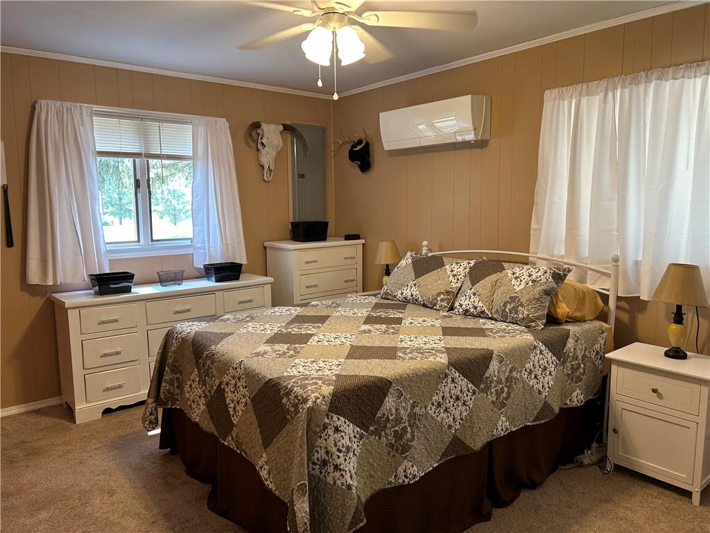 240 Martin Road Scottdale, PA 15683 - Photo 8 of 16 a bedroom with a bed and a chandelier