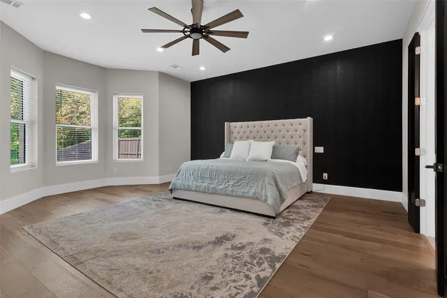 a bedroom with a large bed and a large window