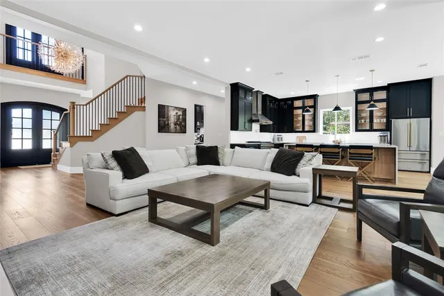 a living room with furniture and a kitchen