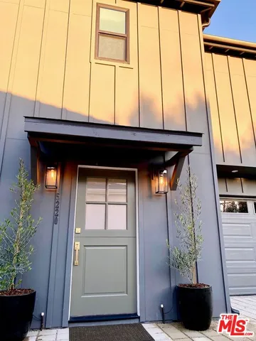 a door view with a potted plant on the wall