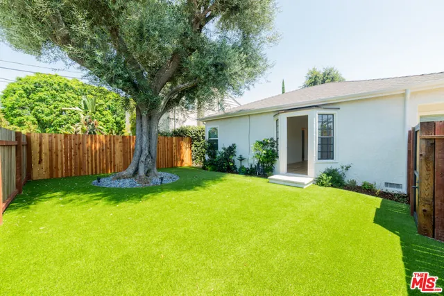 a view of backyard with swimming pool and outdoor seating