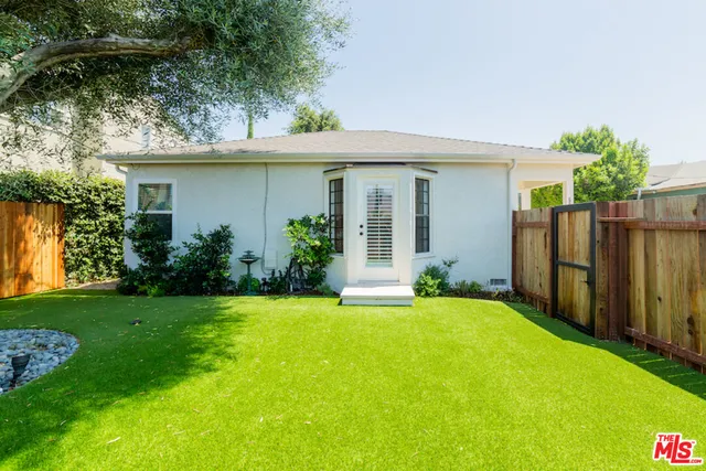 a view of a house with a yard and plants
