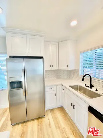 a kitchen with a sink cabinets and stainless steel appliances
