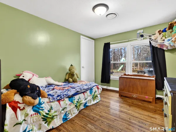 a bedroom with a bed and a television