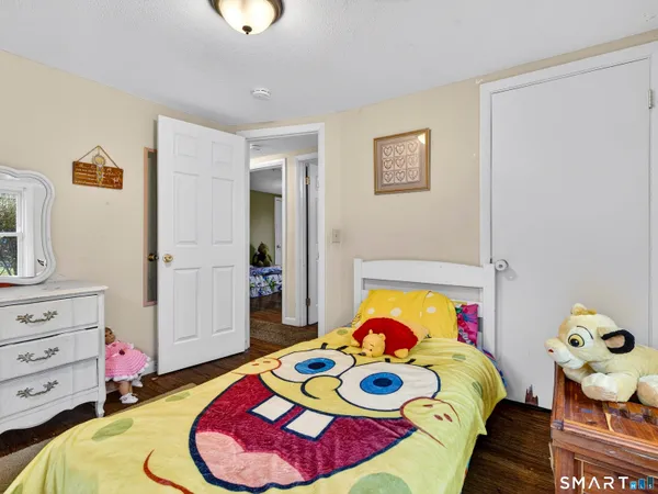 a bedroom with a bed and a dresser