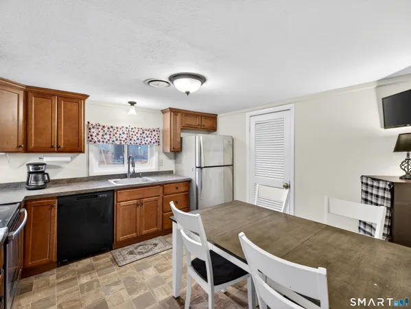 a kitchen with microwave a stove and cabinets