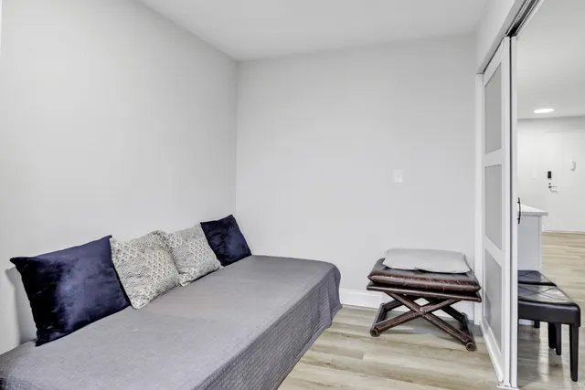 a bedroom with a bed and a couch