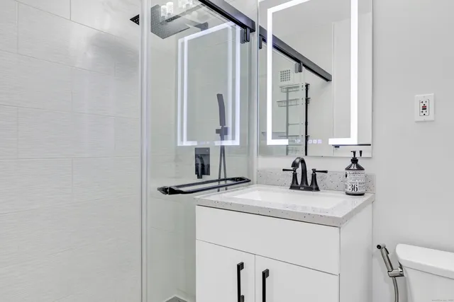 a bathroom with a sink a vanity and a mirror