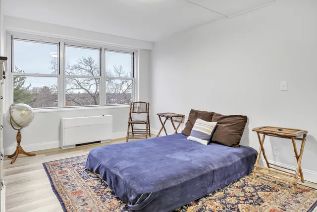a bedroom with a large bed and a window