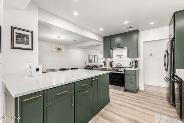 a kitchen with a sink stainless steel appliances and counter space