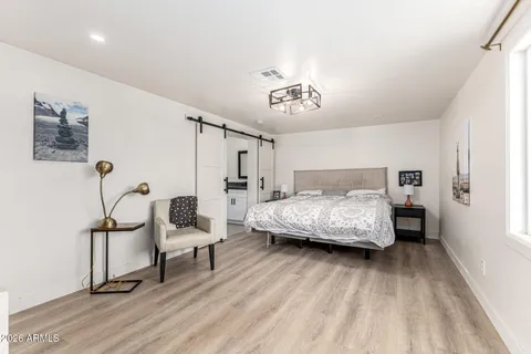 a bedroom with a bed and a chandelier