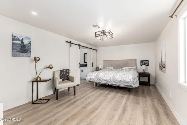 a bedroom with a bed and a chandelier