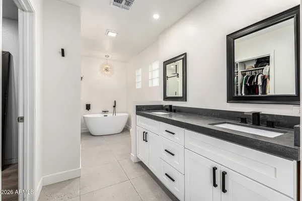 a en suite bathroom with double sink and a large mirror