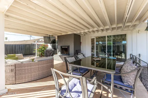 a living room with furniture a fireplace and a large window