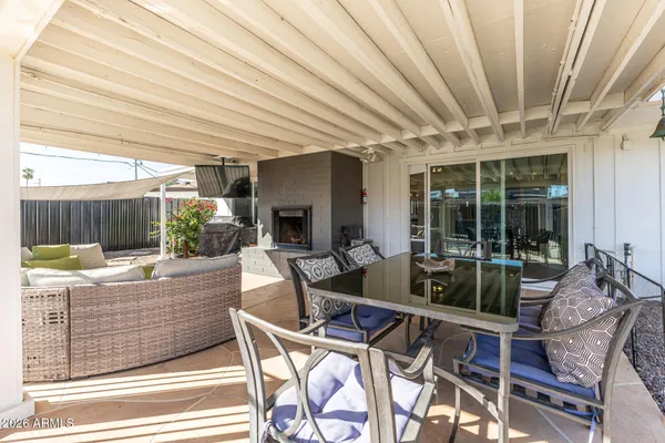 a living room with furniture a fireplace and a large window