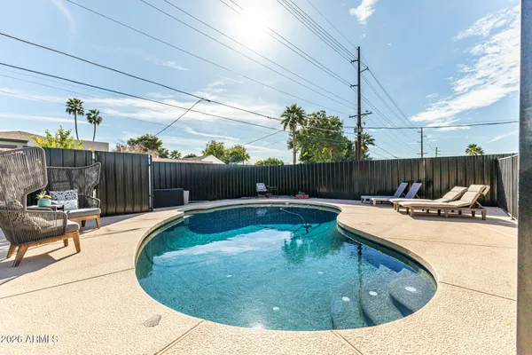 a view of swimming pool with seating space