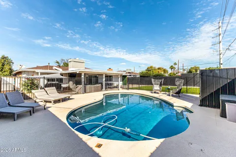 a view of a swimming pool with lounge chairs