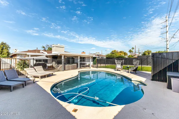 a view of a swimming pool with lounge chairs
