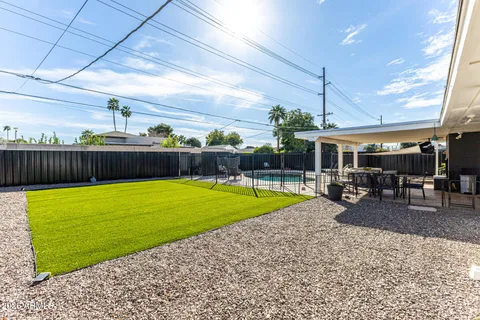 a view of a backyard with furniture and a tub