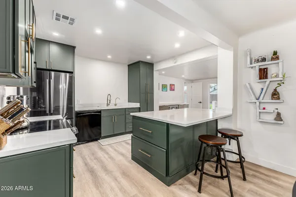 a kitchen with a sink stainless steel appliances and cabinets