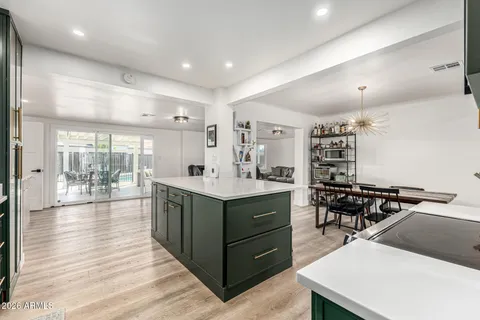 a kitchen with counter top space and wooden floor