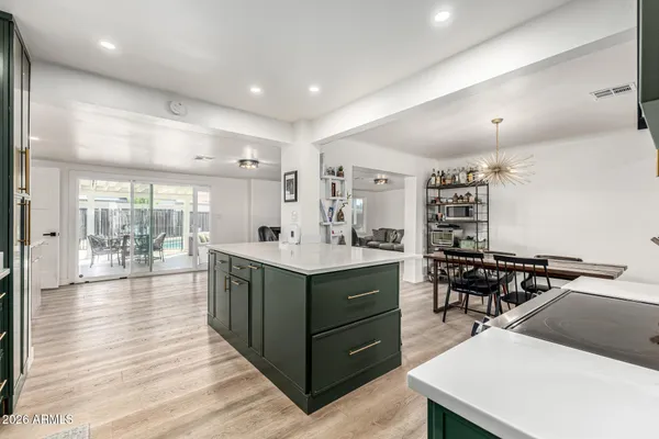 a kitchen with counter top space and wooden floor