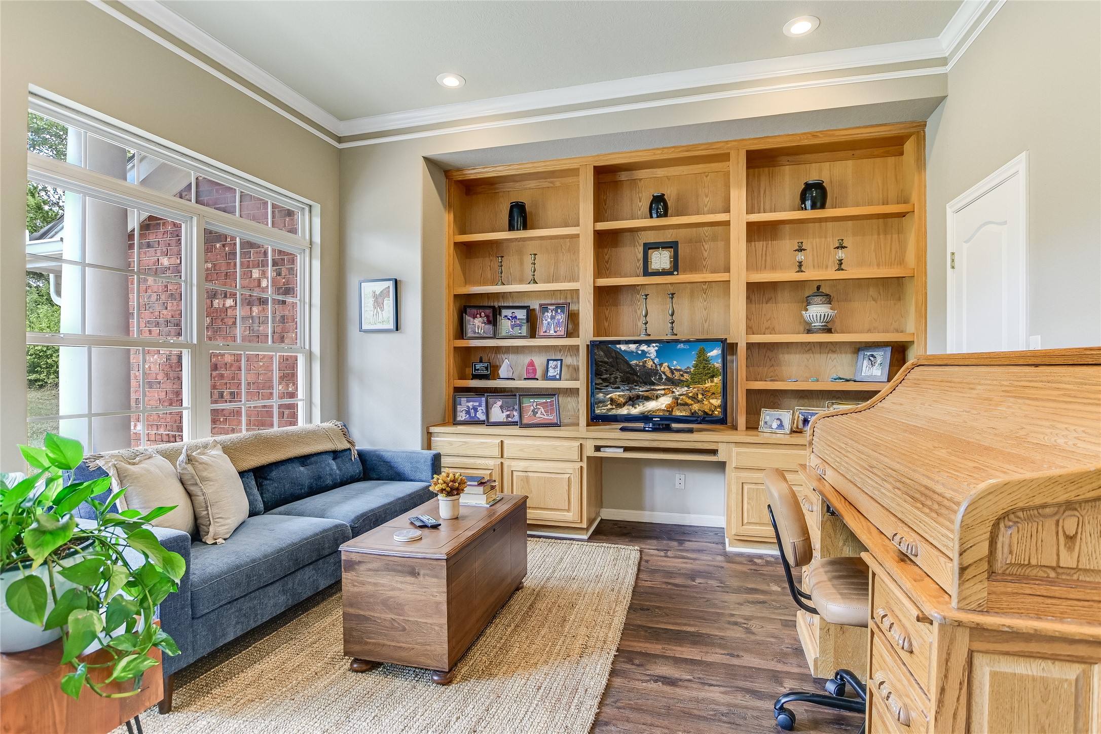 741 Knobbs Road McDade, TX 78650 - Photo 14 of 38 Built-in shelving and ample natural light define this inviting living area.