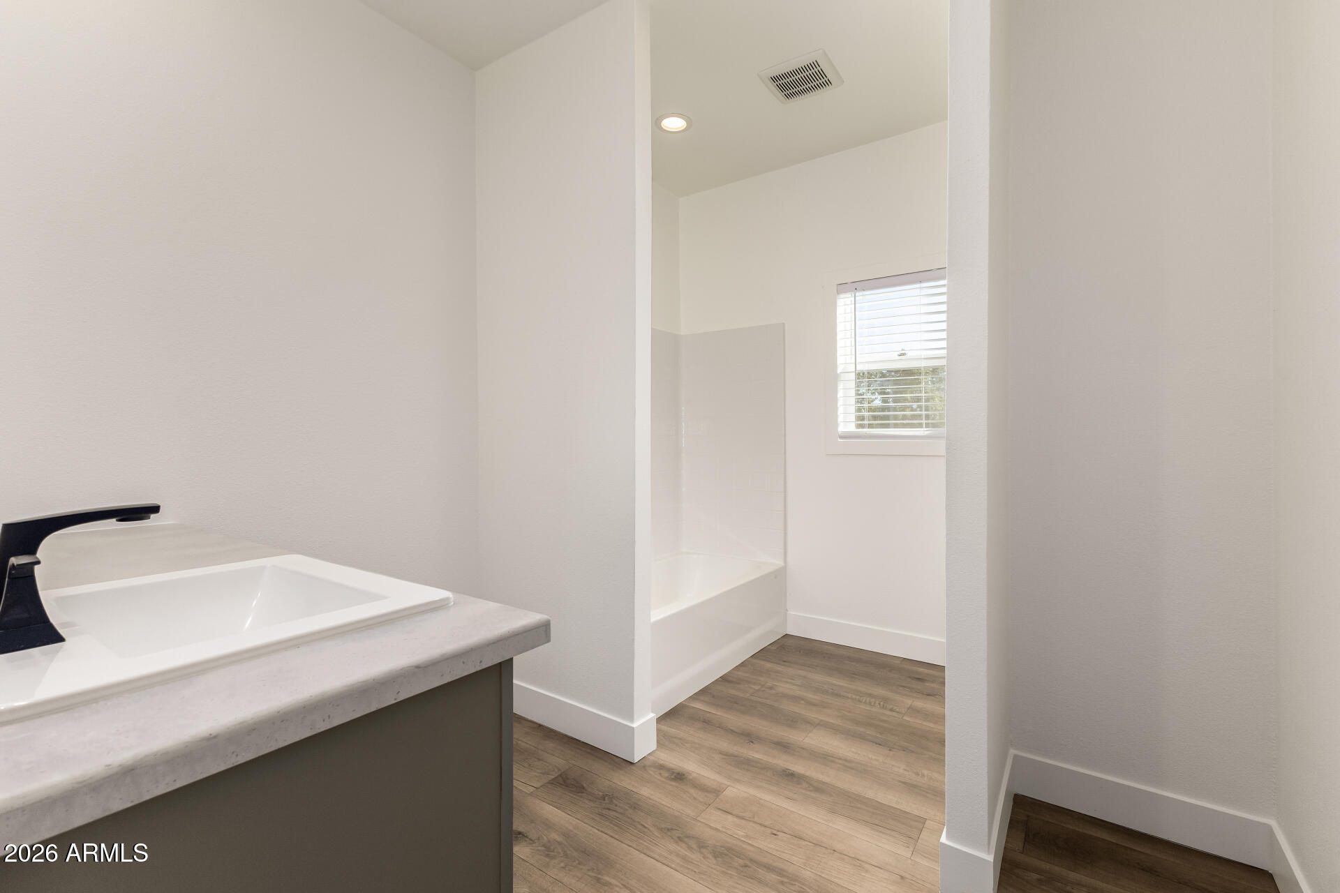 23059 West Rancho Laredo Drive Wittmann, AZ 85361 - Photo 23 of 29 a bathroom with a sink and a mirror