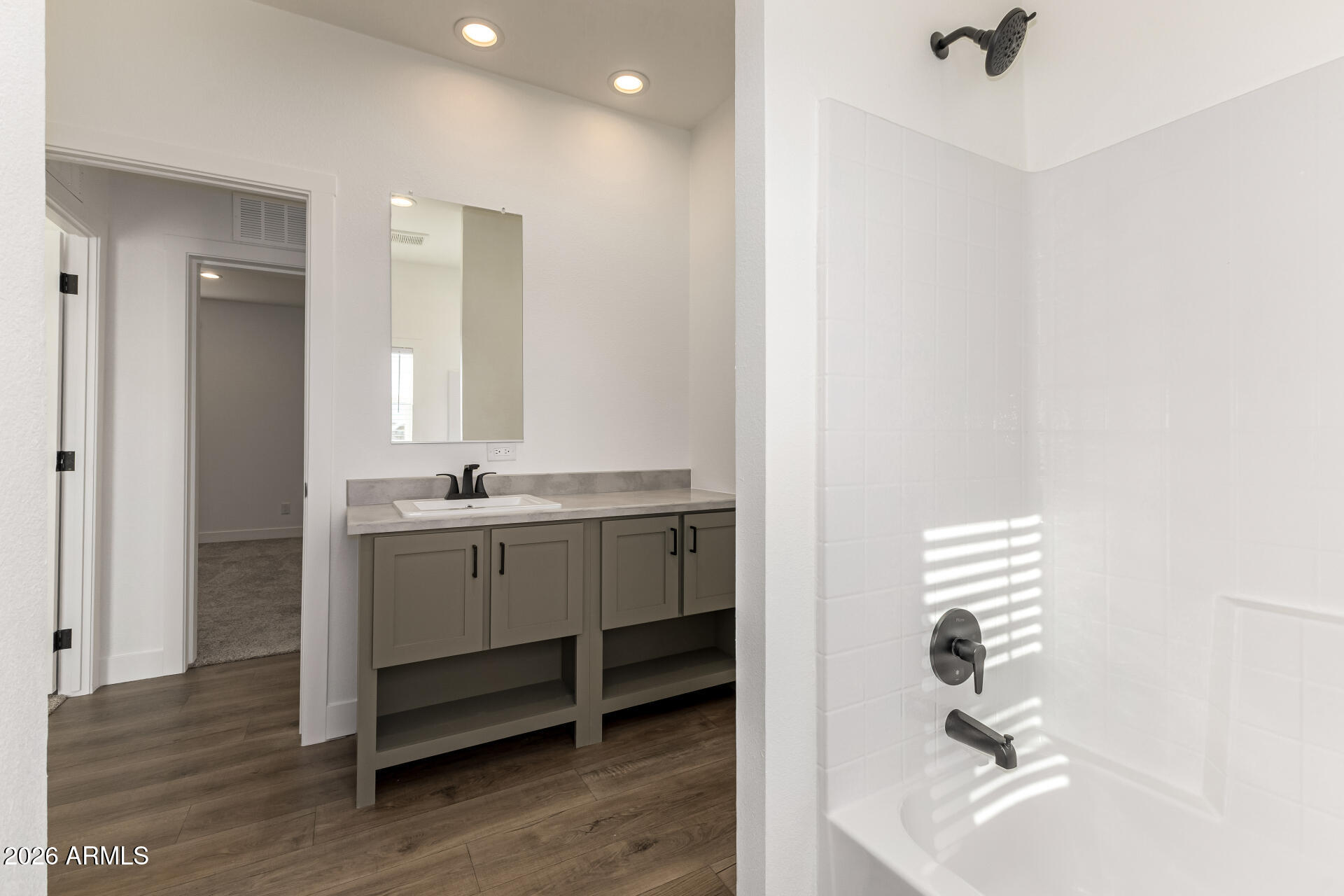 23059 West Rancho Laredo Drive Wittmann, AZ 85361 - Photo 24 of 29 a bathroom with a sink a vanity and a mirror