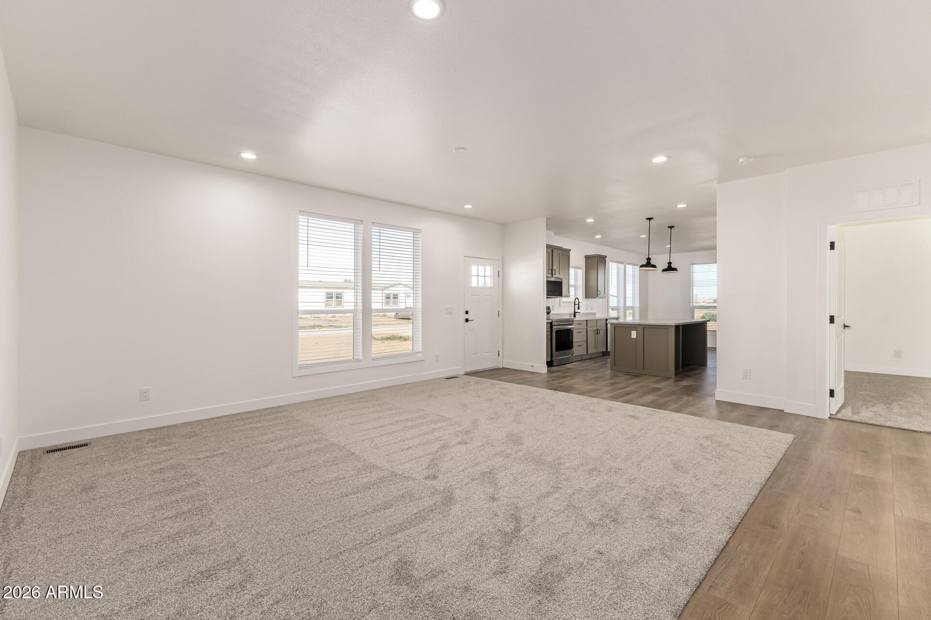 23059 West Rancho Laredo Drive Wittmann, AZ 85361 - Photo 7 of 29 a view of empty room with kitchen and window